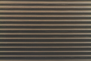 Obraz premium close-up of melantic gray roller shutters covering a shop window