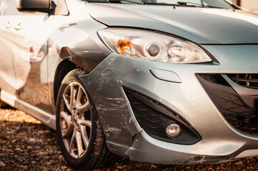 Car crash or accident. Front fender and light damage and scratchs on bumper. Broken vehicle detail ...