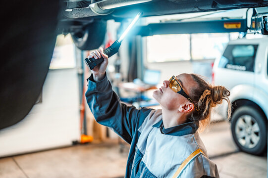 Mechanic Working On A Vehicle In A Car Service. Inspection Of The Car By A Mechanic Of The Chassis Of The Car. Repair Default