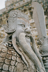 warrior statue in wat arun temple, bangkok, thailand
