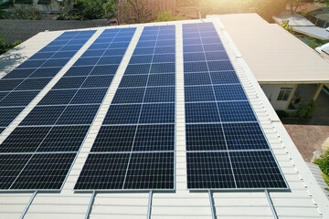 Solar panels installed on a roof of a large industrial building or a warehouse.