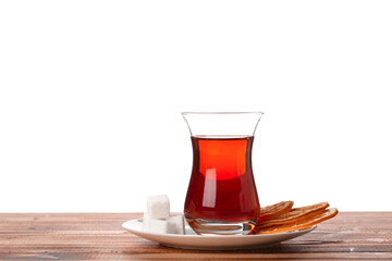 Plate with cup of Turkish tea, sugar and dried orange slices on wooden table against white background