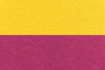 Texture of craft golden and wine paper background, half two colors, macro. Vintage yellow and purple cardboard.