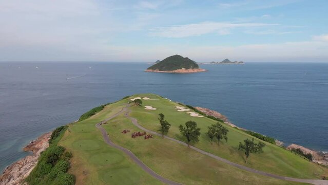 Golf course in Hong Kong. Aerial view with the sea and island in the background. Asia. 
