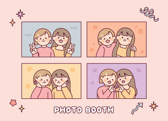 Two girls are taking pictures in various poses. Photo booth.
