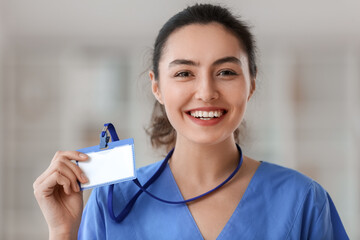 Female medical assistant with badge in clinic
