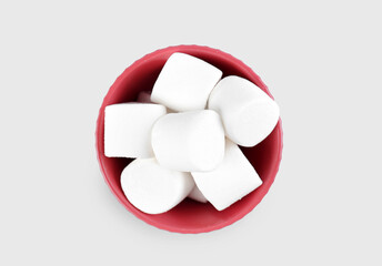 Bowl with delicious marshmallows on grey background