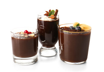 Glasses of various chocolate pudding isolated on white background