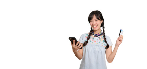 Portrait of beautiful happy young asian woman in denim dress holding credit card and smartphone on white background. studio shot