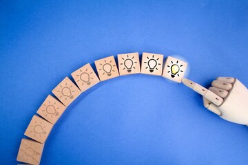 wooden square with dim to bright bulb icon. Brainstorming, education, creative idea and innovation...