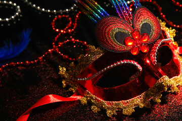 Carnival mask with glitter for Mardi Gras celebration on dark background