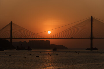 Sunset on suspension bridge in Hong Kong city