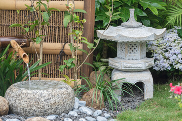 stone lantern and bamboo fountain in Japanese garden