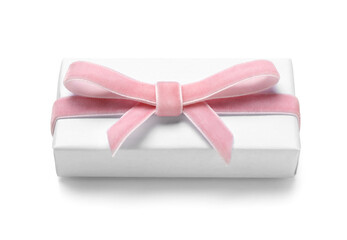 Gift box tied with pink velvet ribbon on white background