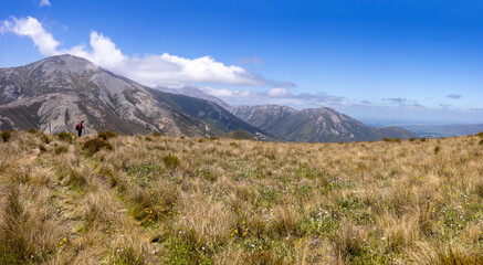 Tourist on mountain walking track, Canterbury, New Zealand