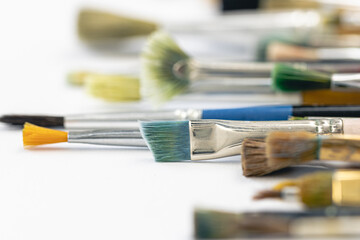 Paint brushes stained with paint, close-up, macro shot.