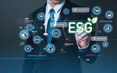 Businessman press the button icon ESG on the screen in environmental, social, and governance in...