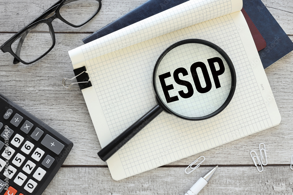 Poster esop, text on magnifier glass on notepad. view from above. calculator near notepad.. esop - short fo