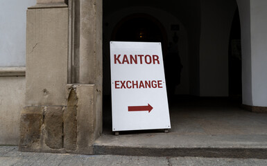 Word kantor in Polish language, means currency exchange. Sidewalk sign or sandwich board with arrow...