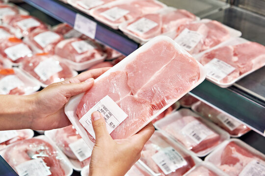 Pork steak in hands buyer in store