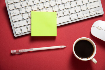 Sticky note with a keyboard and business objects.