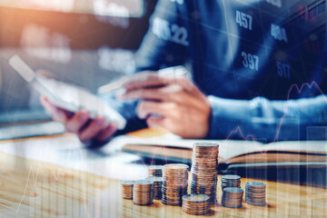 Graph on rows of coins for finance and banking on digital stock market financial exchange and Trading graph Double exposure city on the background