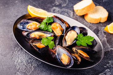 Delicious seafood mussels with sauce and parsley.