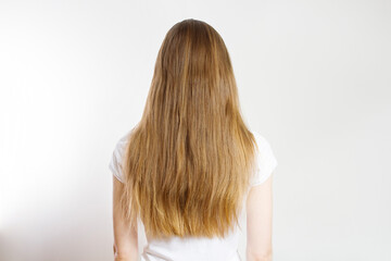 Closeup Caucasian hair type back view isolated on white background. Straight long light brown healthy clean hairstyle. Shampoo concept. Copy space