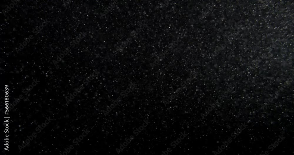 Sticker dust particles overlay on black screen. filmed with red camera in slow motion. abstract background. 