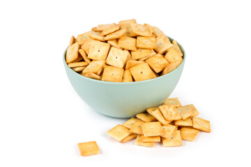 A bunch of cookies in a plate on a white background. Salted square cookie crackers.