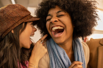 Cheerful multiracial friends laughing and enjoying
