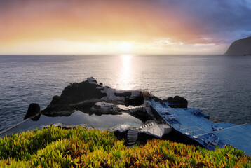 Ocean dramatic sunset over Doca do Cavacas, natural pools in Madeira. Portugal