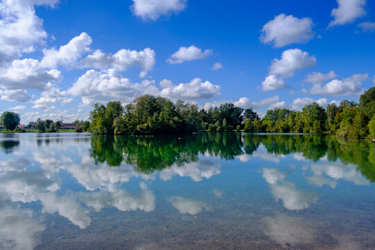 Germany, Bavaria, Clouds reflecting in Waldschwaigsee lake
