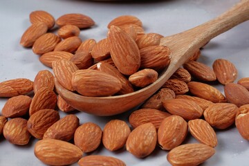 Almond in wooden spoon.on table	