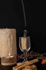 palo santo ,holy stick smoking in a glass cup