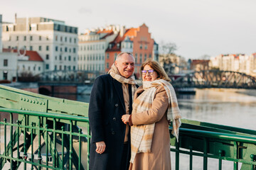 Happy elderly couple standing near railing