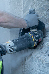 Cutting concrete wall with diamond blade.