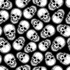 White skulls on a black background. Seamless pattern.