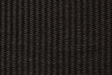 Black ribbed fabric pattern close up as background