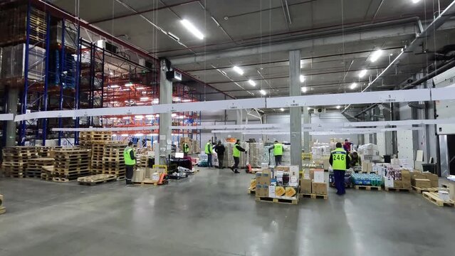 Large modern warehouse timelapse. Workers work in the warehouse general plan time lapse. Workflow in a large warehouse