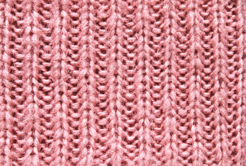 Pink soft chunky woolen sweater surface texture as background

