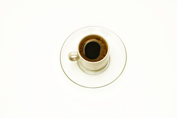 On a white background a cup of coffee on a transparent glass saucer
