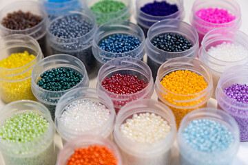 Items for beading - boxes with beads on the table. Development of creative abilities in children. view from above. - boxes with beads on the table. Development of creative abilities in children. 