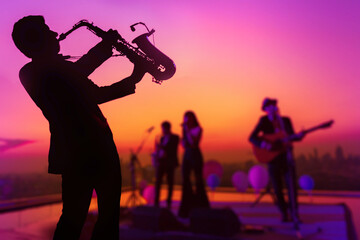 Silhouette saxophone musician man showing with blurry jazz trio band and twilight cityscape background. Double exposure process and copy space - obrazy, fototapety, plakaty