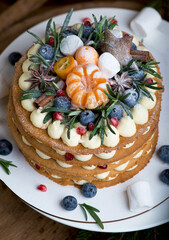 Festive Christmas cake on a rustic wooden stand and holiday decoration