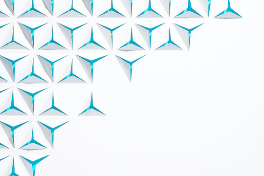 Abstract geometric background with copyspace. Triangles cut out in paper. White and blue color.