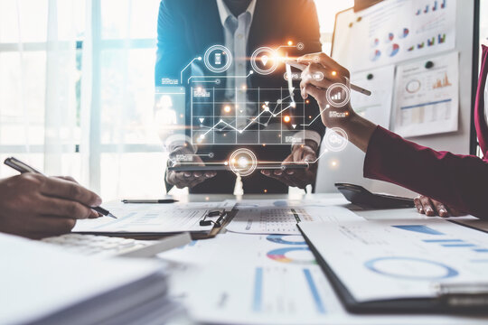 Close Up Of Diverse Colleagues Gather Brainstorm Discuss Financial Statistics At Office Meeting. Finance, Teamwork, Big Data Graphs Charts Concept