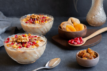 Traditional Turkish delicious mixed dessert, ashura (asure) with pomegranate seeds, walnut, apricot, Noah’s pudding