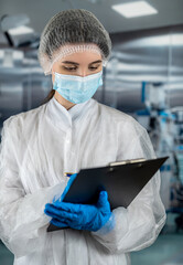 doctor  in  operating room in a modern clinic is writing on a clipboard with information