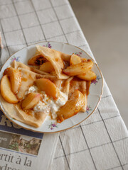 crepe dessert with peach and stracciatella on the table